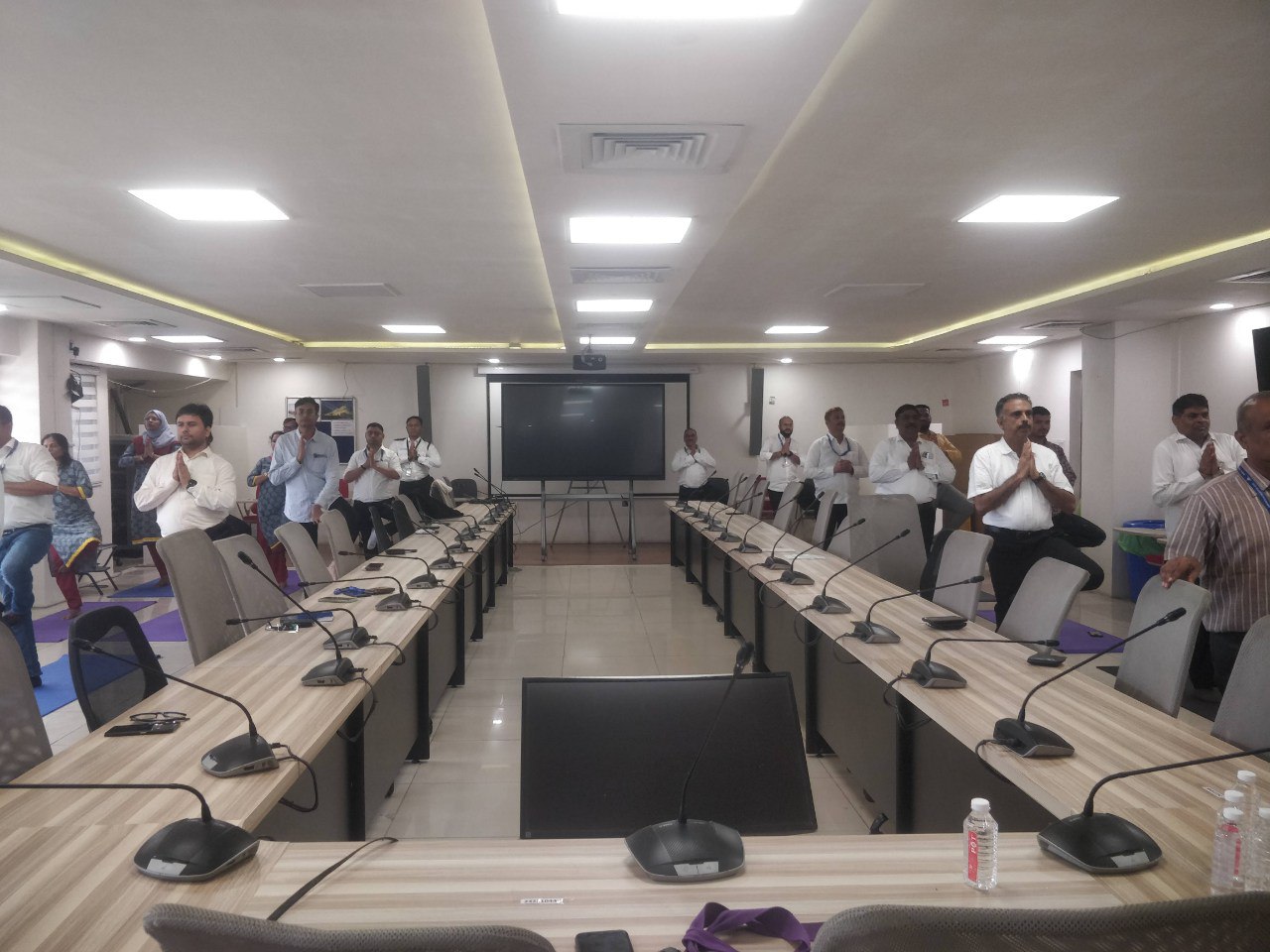Corporate wellness session with employees practicing yoga